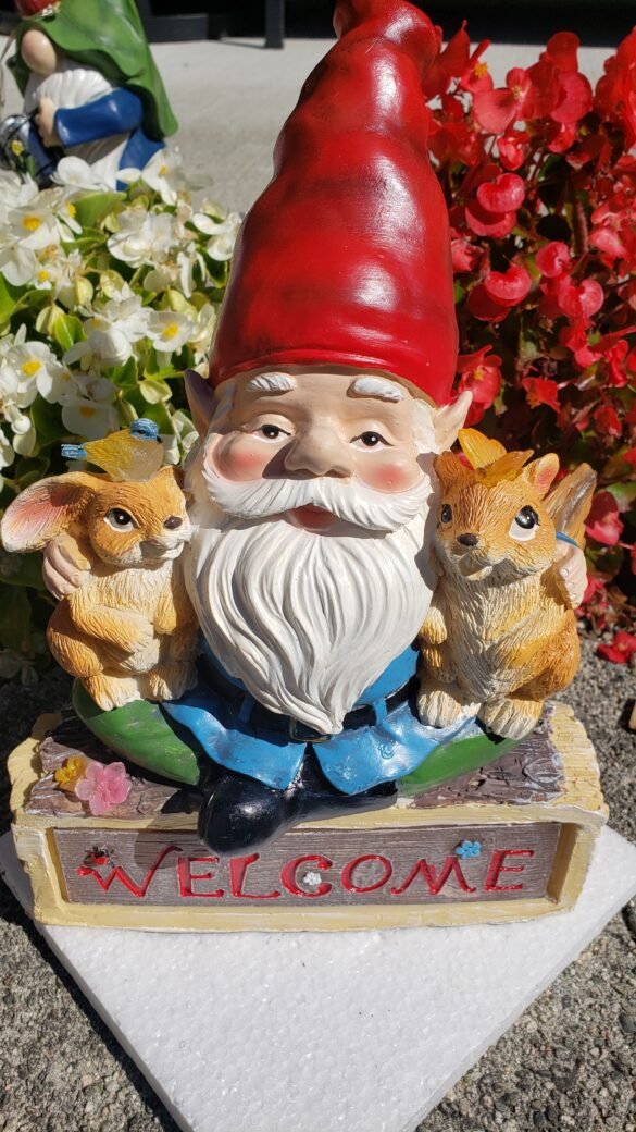 Gnome seated on Welcome sign